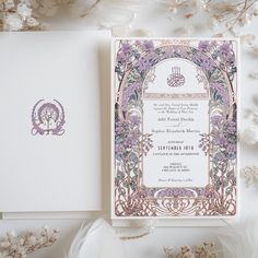 a wedding card with an intricate design on the front and back, surrounded by flowers