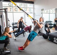 a group of people doing exercises in a gym