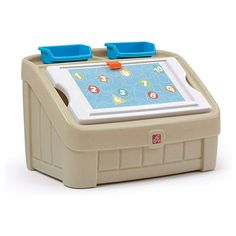 a small toy tablet with blue handles and buttons on the front, sitting on a white surface