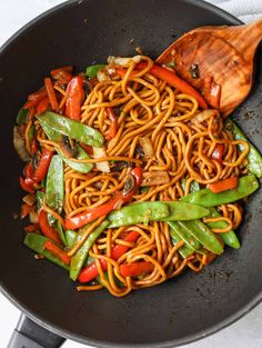 a wok filled with noodles and vegetables