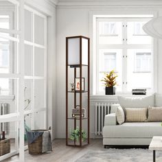 a living room filled with furniture and windows next to a white rug on top of a hard wood floor