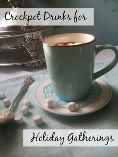 a cup of hot chocolate with marshmallows on a saucer