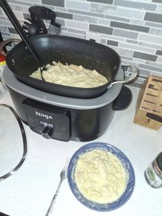 an image of food being cooked in the pot on the kitchen counter with utensils