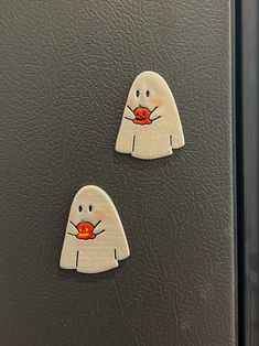 two magnets that are on the side of a refrigerator