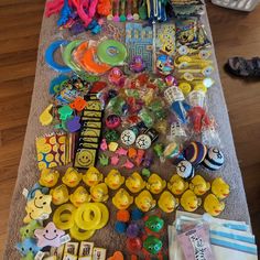 a table topped with lots of different types of toys and decorations on top of a wooden floor