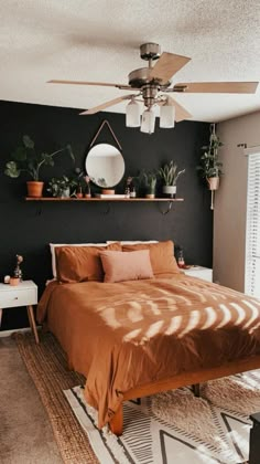 a bed sitting in a bedroom next to a window with potted plants on it