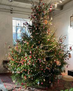 a decorated christmas tree in an old building