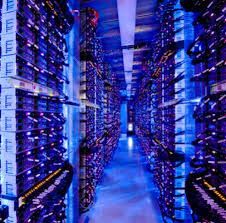 rows of servers in a data center filled with lots of wires and lights on the ceiling