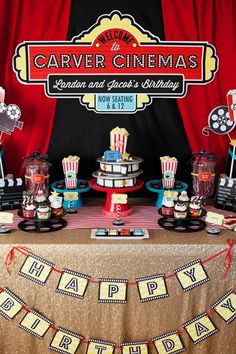 a table topped with lots of cakes and cupcakes