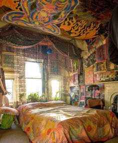 a bedroom with a large bed covered in colorful blankets