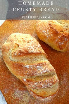 two loaves of bread sitting on top of a cutting board with the words homemade crusty bread