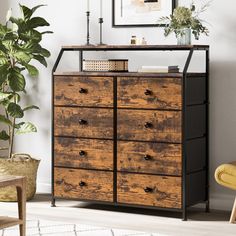 a wooden dresser sitting next to a plant in a living room