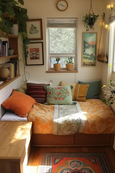 a small bedroom with a bed, bookshelf and plants on the window sill