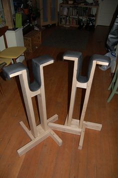 three wooden chairs sitting on top of a hard wood floor