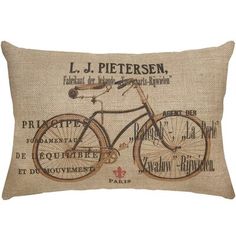 a pillow with a bicycle on it and french words written in different languages around the edges