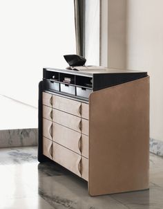 a dresser with a mirror on top of it in front of a wall and floor