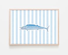 a blue and white striped wall hanging with a fish on it's back side