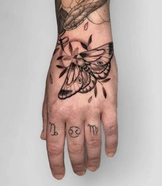 a person's hand with a butterfly on it and the word mom written in black ink