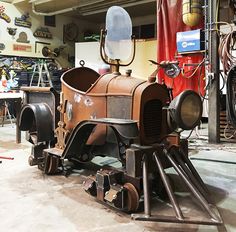 an old fashioned steam engine sitting in a garage