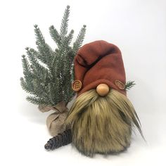 a gnome's hat and pine needles are sitting next to each other on a white background