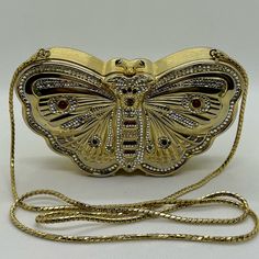 Really Beautiful And Rare Vintage Judith Leiber Brushed Gold Butterfly Minaudiere Bag With Swarovski Crystals And Cabochon Stones Of Red, Black And Green. Closure Topped With 2 Cabachon Stones. Genuine Gold Leather Interior. Length ~ Approx 6 1/4” Depth ~ Approx 3 3/4” Chain ~ Approx 38” In Excellent Condition With Barely If Any Signs Of Wear! No Missing Crystals Or Stones. Please See Photos. Comes From A Smoke Free Home. Comes With Judith Leiber Dust Pouch. Minaudiere Bag, Rare Butterfly, Judith Leiber Bags, Judith Leiber, Gold Butterfly, Gold Leather, Dream Clothes, Leather Interior, Swarovski Crystals