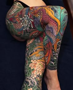 a woman with colorful tattoos on her legs