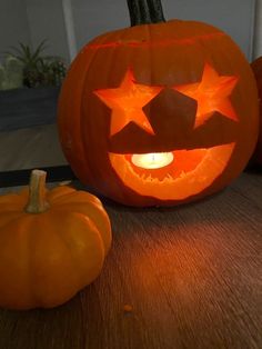 two pumpkins with faces carved to look like stars