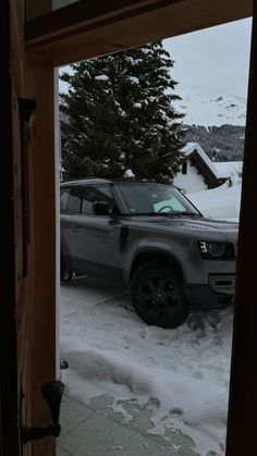 an suv is parked in the snow outside