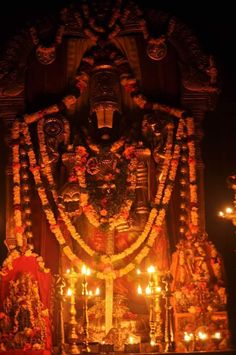 the statue is decorated with candles and garlands