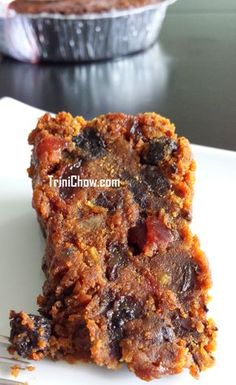 a piece of cake sitting on top of a white plate next to a cupcake tin