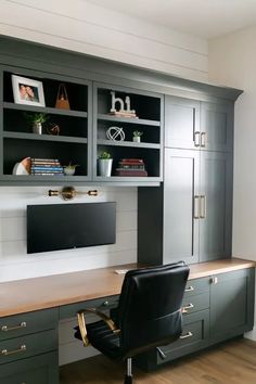 an office with gray cabinets and black chairs