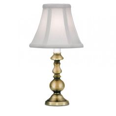 a gold lamp with a white shade on it