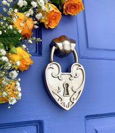 a blue door with flowers and a lock on it