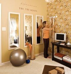 a woman standing in a living room next to a tv and exercise ball on the floor