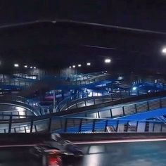 a man riding a skateboard down an escalator in a parking lot at night