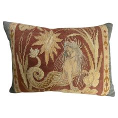 a decorative pillow with an image of a mermaid on it