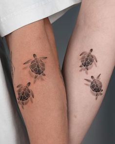 two people with matching tattoos on their arms