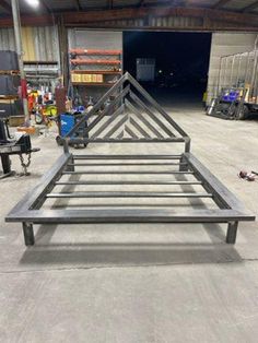 an empty metal bed frame in a warehouse