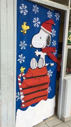 a door decorated with a snoopy christmas scene