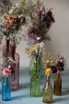 three vases filled with different types of flowers