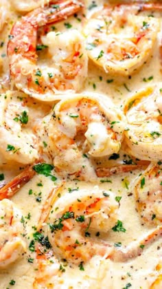 shrimp and grits in a white sauce with parsley on the side, ready to be eaten