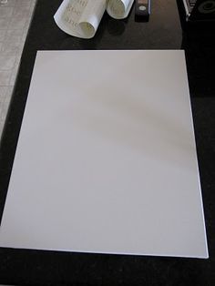 a white sheet of paper sitting on top of a counter next to a pair of scissors