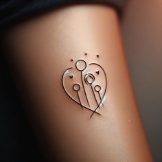 a small tattoo on the side of a woman's stomach with two hearts and stars