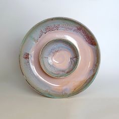 a white and pink bowl sitting on top of a table