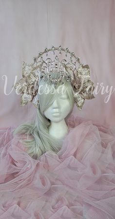 This pink fairy flower headpiece glam and grand.  A beautiful floral halo headdress, this rose gold  and silver flower crown has an elevated halo and a magical forehead feature. This headpiece has spectacular large light pink. blush pink flowers with wired petals.  As such, they can be moved and adjusted to frame the face. A shiny scrolled crown with high end Austrian crystals in will take your costume or outfit to the next level. In addition to this is a gorgeous Elven style forehead piece with Gold Flower Crown, Elven Style, Sailor Moon Wands, Halo Headpiece, Pink Halo, Flower Halo, Floral Halo, Pink Fairy, Rose Gold Flower