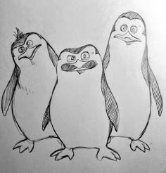 three penguins are standing next to each other