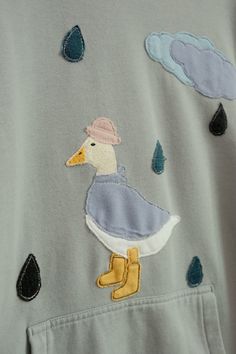 the duck is wearing a hat and rain boots