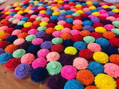 multicolored pom - poms laid out on the floor