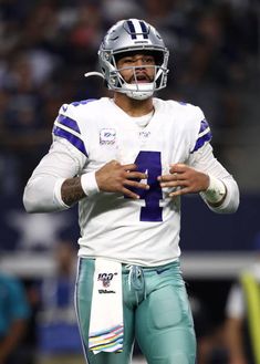 a football player holding a ball in his hands