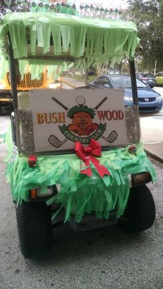 a golf cart decorated with green grass and bows